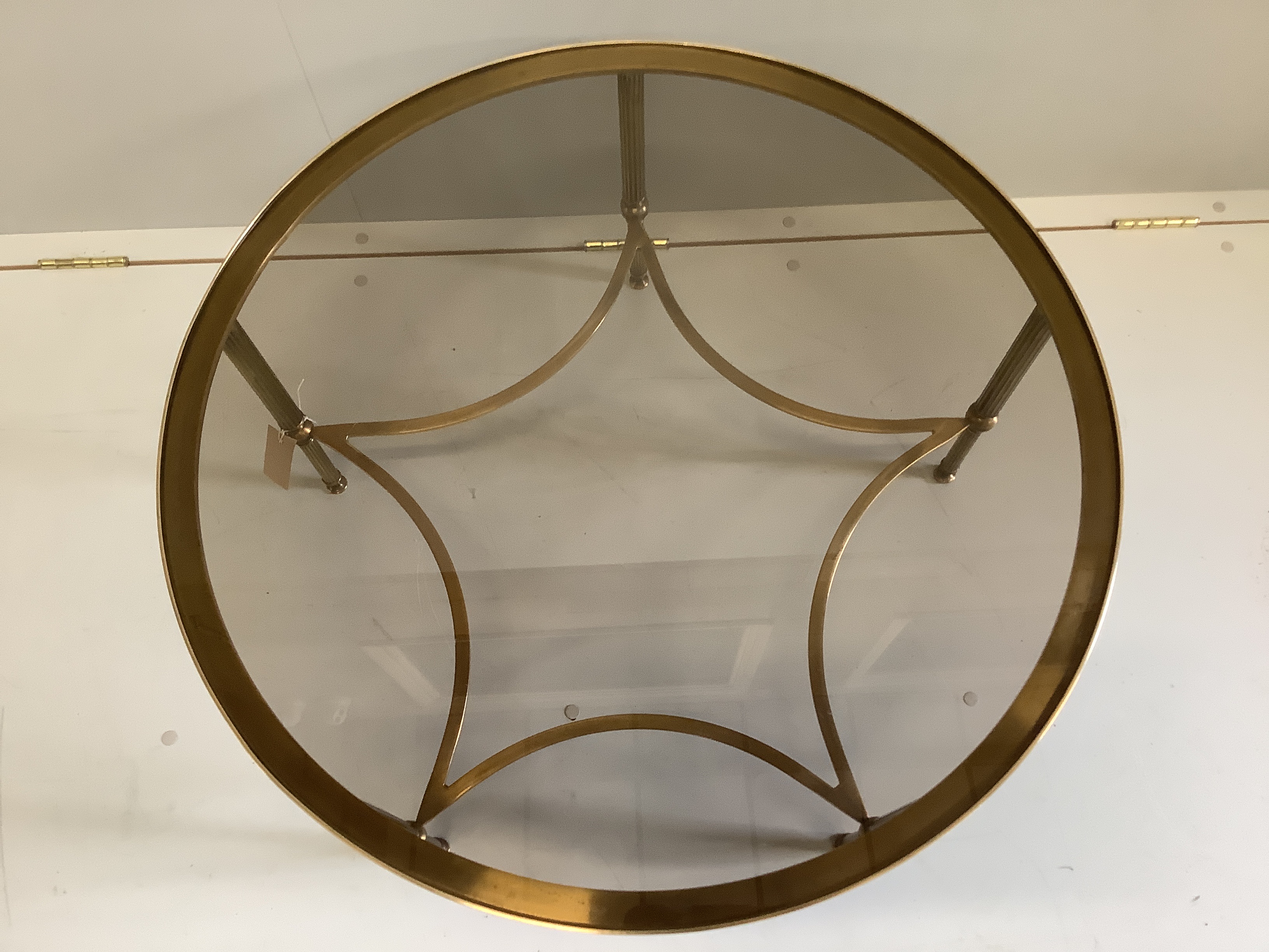 A Maison Jansen style circular brass, glass top coffee table, 76cm diameter, height 42cm